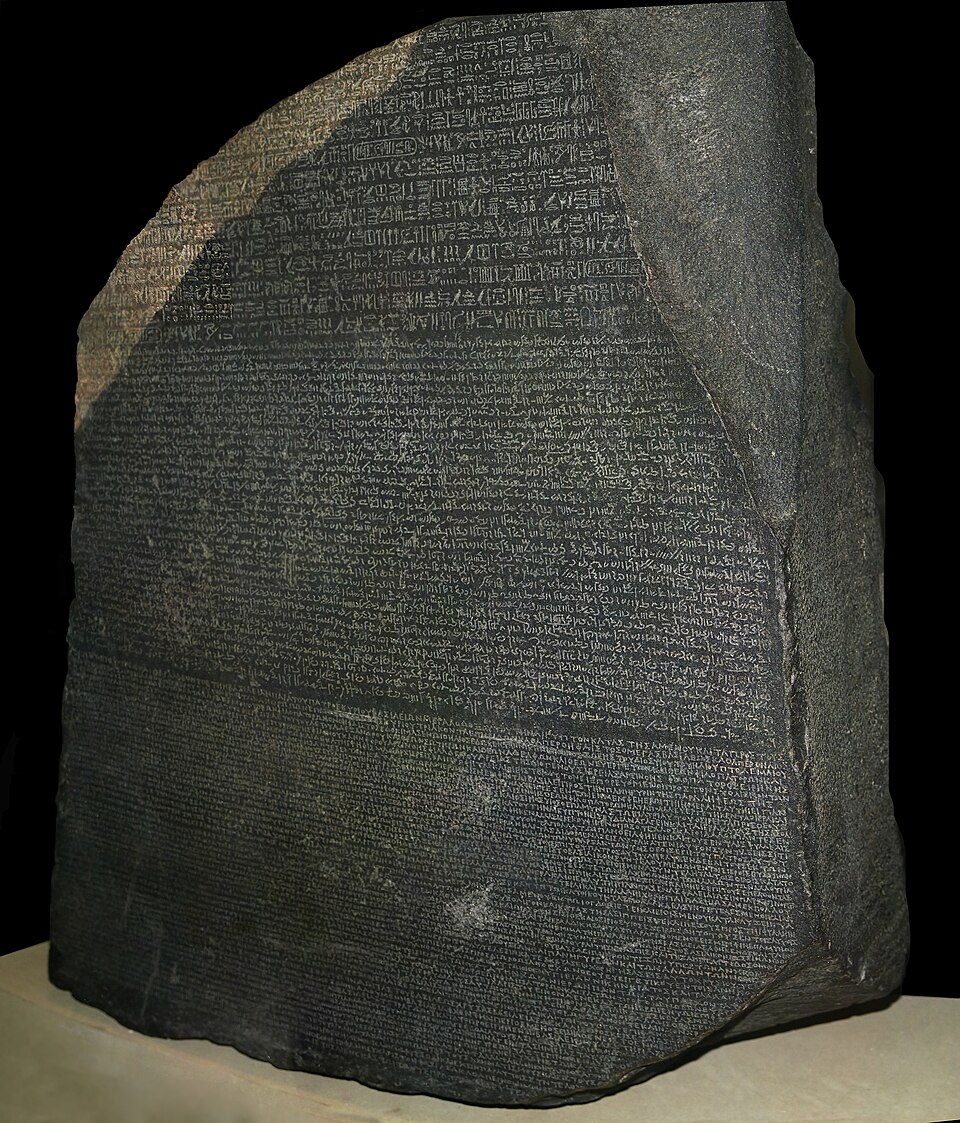 The Rosetta Stone, whose parallel texts let Champollion decipher Egyptian hieroglyphs in 1822.